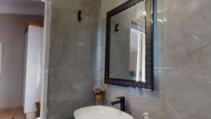 a bathroom with a sink and a mirror at San Lameer Villa 2910 by Top Destinations Rentals in Southbroom