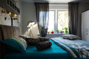 a bed with pillows on it in a bedroom at Apartman MIMA in Karlovac