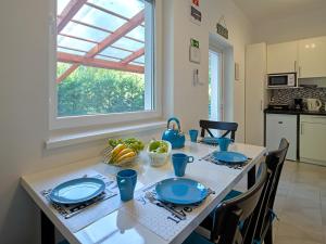 a kitchen with a table with blue plates on it at Fövenyes House in Balatonudvari