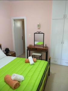 a bedroom with a bed with a desk and a mirror at AGNANTI in Palekastron