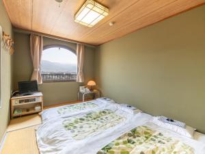 Postel nebo postele na pokoji v ubytování Tabist Hotel Sun Plaza Fuefuki Isawa + 36 fotografií