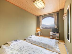 Postel nebo postele na pokoji v ubytování Tabist Hotel Sun Plaza Fuefuki Isawa