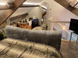 a living room with a couch and a large mirror at The Hive at Poppi-Red in Hawkshead +87 photos