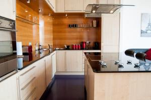a kitchen with white cabinets and a black counter top at City Views Apartment City Centre FreeParking in Glasgow
