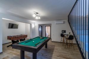a room with a pool table and a staircase at Villa Vanda in Diminići