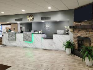 a lobby of a dental office with a fireplace at Quality Inn Terre Haute University Area in Terre Haute