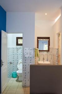 a bathroom with a toilet and a sink at Andasibe Lemurs Lodge in Andasibe