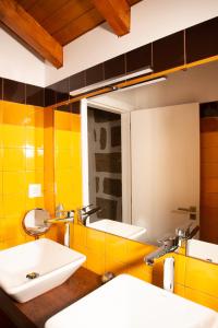 La salle de bains est pourvue de 2 lavabos et d'un miroir. dans l'établissement Quinta do Mirante, à Castelo de Paiva