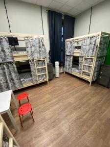 a room with a red chair and shelves of boxes at Good Night rooms & hostel in Murmansk