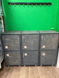 a group of filing cabinets in a room with a green wall at Good Night rooms & hostel in Murmansk