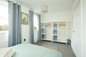 a white bedroom with a bed and a window at Halifax Gorgeous New Home - 3 bedrooms in Halifax