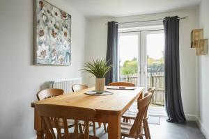 a dining room table with chairs and a large window at Halifax Gorgeous New Home - 3 bedrooms in Halifax