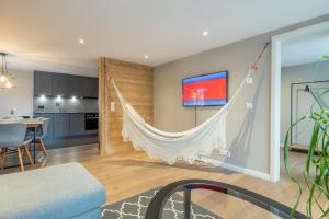 a living room with a hammock hanging on the wall at Ahorn in Interlaken