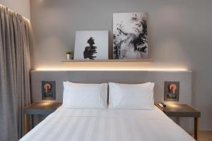 a bedroom with a white bed with two night stands at The Residences Kalamata in Kalamata