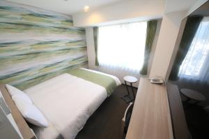 Postel nebo postele na pokoji v ubytování Kuretake Inn Premium Numazu Kitaguchi Ekimae