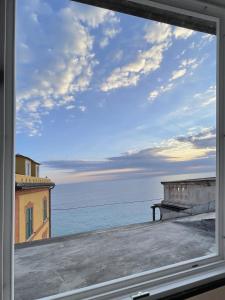 a view of the ocean from a window at Via Garibaldi 75 - Attic sea view in Camogli