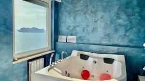 a bath tub in a bathroom with a window at Suite al mare in Taranto