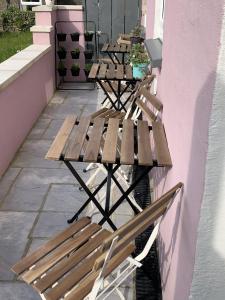 two wooden tables and chairs sitting on a patio at Min-Y-Fford sleeps 6 plus pet in Newport Pembrokeshire