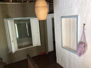 a room with two windows and a lamp at Casa Grande Flats in Abraão