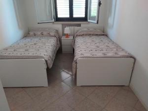 Posteľ alebo postele v izbe v ubytovaní Residenza Silvestro a 2 minuti dalla fiera e dal mare!