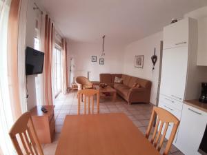 a living room with a table and a couch at Wellental in Breege