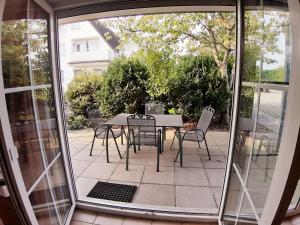 a patio with a table and chairs on a patio at Wellental in Breege +3 photos