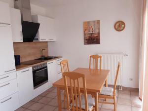 a kitchen with a table and chairs and a sink and a stove at Wellental in Breege