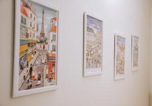 a group of paintings hanging on a wall at Palazzo dei Lari in Scafati