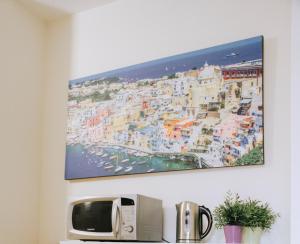 a painting hanging on a wall above a microwave at Palazzo dei Lari in Scafati +20 photos
