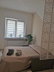 a bedroom with a large bed and a window at "Nonna Maria" in Venegono Superiore