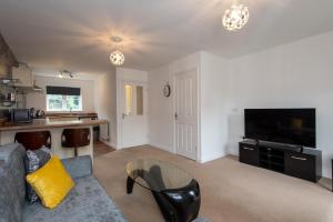 a living room with a couch and a table at Park View in Billingham