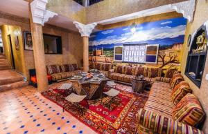 a living room with couches and a table at Riad Sephora in Tinerhir
