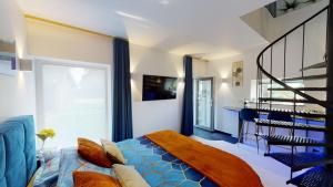 a bedroom with a blue bed and a staircase at B&B Ferienhof AB Wellness Suite in Bullange