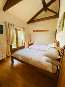 a bedroom with two beds and a window at Field Farm Holiday Cottages and Glamping in Anderby