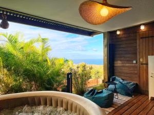 a balcony with a view of the ocean from a house at Villa Moai 974 in Saint-Leu