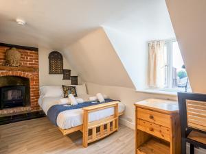 a bedroom with a bed and a fireplace at Pass the Keys Renovated Apartment in the Centre of Canterbury in Canterbury