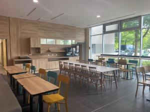 a dining room with tables and chairs in a restaurant at Apparthotel Torcy in Torcy