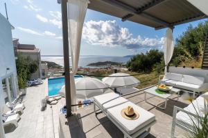 a patio with a view of the ocean from a house at NEW! Villa Lea 5-bedroom villa with private pool and amazing views of city and sea in Makarska