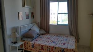a small bedroom with a bed and a window at Residencial Marina Club in São Pedro da Aldeia +57 photos