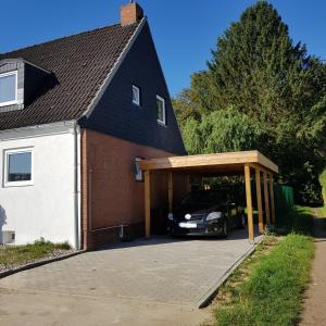 a garage with a car parked inside of a house at Ostseetraum in Lübeck