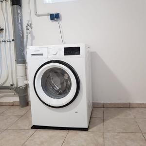 a white washing machine sitting in a room at Ostseetraum in Lübeck
