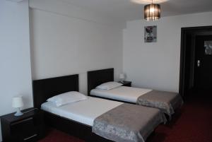 Postel nebo postele na pokoji v ubytování Hotel Corona