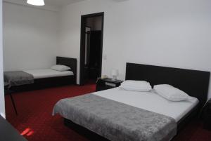 Postel nebo postele na pokoji v ubytování Hotel Corona
