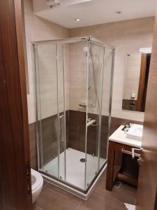 a bathroom with a shower and a toilet and a sink at Apartment B513 in Jahorina