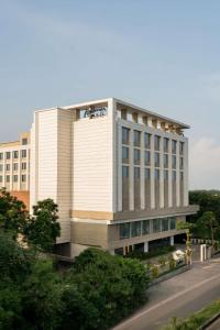 a large white building with a lot of windows at Radisson Bhopal in Bhopal