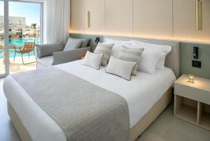 a bedroom with a large white bed with pillows at Atlantica Aqua Blue in Protaras