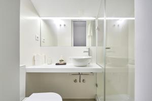a white bathroom with a sink and a shower at Charming house with terrace in Lisbon.WIFI. in Lisbon +27 photos