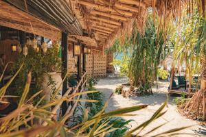 an outdoor patio with plants and a building at The Lazy Lodge in Ko Lanta