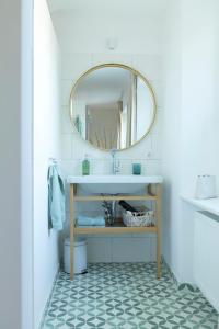 a bathroom with a sink and a mirror at Rotes Haus Bregenz Garten Wohnung in Bregenz