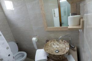 a bathroom with a sink and a toilet at La Helesteu in Lăzăreşti +33 photos
